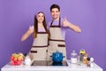 Photo of funky confident boyfriend girlfriend dressed chef showing two thumbs up hugging isolated purple color