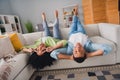 Photo of funky cool couple dressed casual outfits lying upside down having fun showing v-sing indoors house room Royalty Free Stock Photo