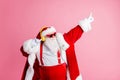 Photo funky cool santa claus have x-mas christmas party event celebration listen headphones music raise fingers dance