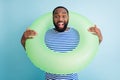 Photo of funky dark skin guy hold green life buoy ready swim ocean sea traveler see sale banner advert enjoy shopping