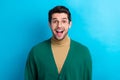 Photo of funky excited man wear green cardigan spectacles open mouth isolated blue color background