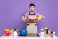 Photo of funky impressed boyfriend dressed chef outfit looking burnt dinner isolated purple color background