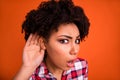 Photo of funky impressed woman wear plaid shirt arm ear listening you isolated orange color background