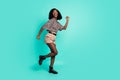 Photo of funky lady run look empty space wear leopard print shirt shorts boots isolated turquoise color background Royalty Free Stock Photo