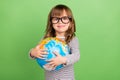 Photo of funky little blond hair girl hold globe wear striped shirt isolated on green color backgound