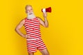 Photo of funky old man wear oldschool striped swimsuit hold megaphone and announce free cocktails party isolated on Royalty Free Stock Photo