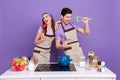 Photo of funky pretty boyfriend girlfriend dressed chef singing kitchen microphones isolated purple color background