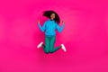 Photo of funky pretty dark skin lady wear blue hoodie jumping high showing hard rock sign smiling isolated pink color Royalty Free Stock Photo