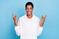 Photo of funky pretty trans girl wear white sweatshirt showing two hard rock gestures isolated blue color background Royalty Free Stock Photo