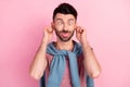 Photo of funky silly young man stick out tongue hold hands ears make funny face isolated on pink color background Royalty Free Stock Photo