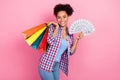 Photo of funky wavy hairdo lady hold bags money wear plaid shirt jeans isolated on pink color background