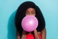 Photo of funky young dark skin woman blow balloon festive mood face isolated on teal color background