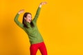 Photo of funky youngster lady dance disco hit party wear green pullover red trousers isolated yellow color background