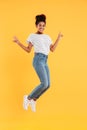 Funny african joyful lady jumping and smiling isolated