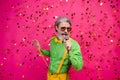 Photo of funny aged grandpa club party singing karaoke microphone confetti fall excited singer wear sun specs green