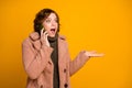 Photo of funny cheerful lady hold telephone speak friends sharing news gossips rumors wear casual pink coat warm green