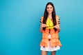 Photo of funny cheerful lady tourist long hairstyle orange emergency life vest hold painted yellow yacht wear white Royalty Free Stock Photo