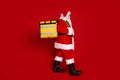 Photo of funny cheerful man pensioner dressed santa claus costume walking carrying delivery rucksack smiling isolated Royalty Free Stock Photo