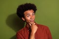 Photo of funny clever man with afro hairstyle dressed brown shirt hand on chin think business ideas isolated on khaki