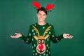 Photo of funny clueless guy shrug shoulders wear horns deer ornament pullover isolated green color background