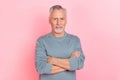 Photo of funny confident man pensioner dressed grey shirt arms folded isolated pink color background Royalty Free Stock Photo