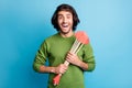 Photo of funny crazy guy hold many heart arrows open mouth wear green sweater isolated blue color background