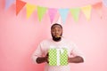 Photo of funny dark skin guy visit family meeting mother birthday noisemaker in mouth hold big giftbox wear sweater