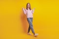 Photo of funny dreamy cheerful girl walk on yellow background