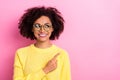 Photo of funny dreamy woman dressed kitted pullover glasses pointing looking empty space isolated pink color background Royalty Free Stock Photo