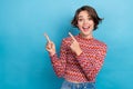 Photo of funny excited lady direct index fingers empty space shocking announcement wear print shirt isolated blue color