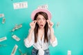 Photo of funny excited young woman dressed white shirt cap arms glasses money open mouth isolated teal color background