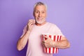 Photo of funny grandfather cuddle paper box eat popcorn toothy smile wear pink t-shirt isolated purple color background