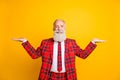 Photo of funny grandpa guy holding open palms empty space two novelty products wear lumberjack suit red blazer tie