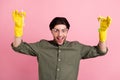 Photo of funny guy hold two chemical tube raise hands wear goggles gloves khaki shirt  pink color background Royalty Free Stock Photo