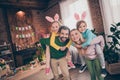 Photo of funny laughing positive family have fun mom and dad hold piggyback kids spend free time at home house