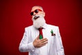 Photo of funny old white hair man hand chest look empty space wear eyewear white jacket isolated on red color background Royalty Free Stock Photo