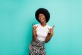 Photo of funny pretty dark skin woman dressed casual outfit smiling showing hard rock sign isolated turquoise color Royalty Free Stock Photo