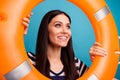 Photo of funny pretty lady long hair look inside orange emergency life buoy empty space good mood positive emotions wear