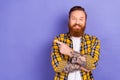 Photo of funny redhead foxy bearded tattoo guy wear plaid shirt direct finger empty space banner isolated purple color