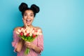 Photo of funny shocked dark skin lady hold big tulips bunch blossom birthday surprise open mouth hand on cheek wear