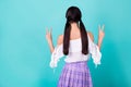 Photo of funny slim lady wear white top standing back showing v-signs empty space isolated turquoise color background