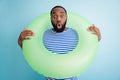 Photo of funny speechless dark skin guy hold green life buoy ready swim ocean sea traveler see sale banner advert not
