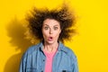 Photo of funny stunned lady wind blow curly hairdo open mouth wear jeans shirt isolated yellow color background