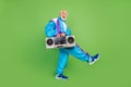 Photo of funny sweet mature guy dressed blue sport suit smiling walking listening boom box isolated green color Royalty Free Stock Photo