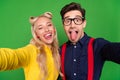 Photo of funny tricky young lady guy dressed pinup outfits tacking selfie showing tongues winking isolated green color