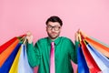 Photo of funny unsure guy wear green shirt spectacles rising bargains shrugging shoulders isolated pink color background