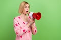 Photo of funny young girl blonde pink cardigan scream megaphone dissatisfied communicate empty space on green