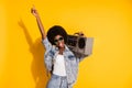 Photo of funny young lady wear casual denim outfit arm glasses holding boombox pointing empty space isolated yellow Royalty Free Stock Photo