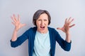 Photo of furious angry age woman wear blue cardigan screaming rising arms isolated green color background