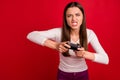 Photo of furious woman out of control losing video game while isolated with red background Royalty Free Stock Photo